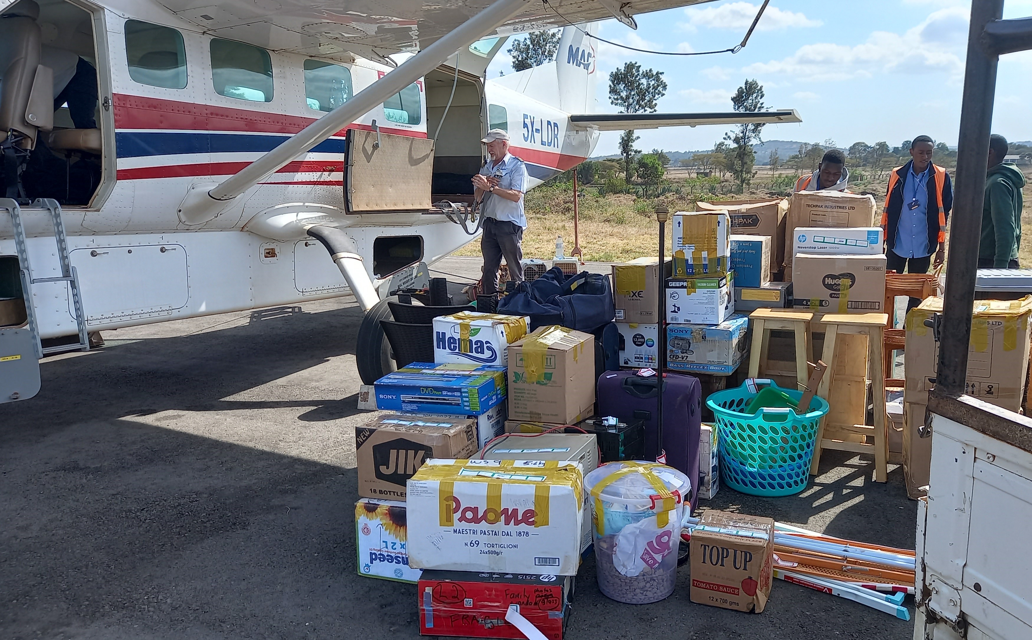 Mark Liprini unloading belongings on arrival in Arusha