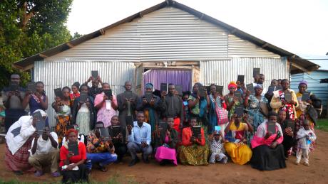 Locals at the islands display their new Bibles