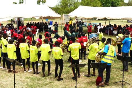 Refugees at Bidibidi settlement playing brass instruments 