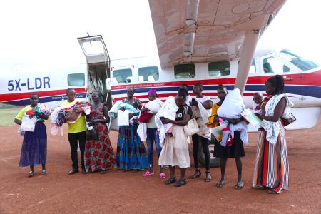 Babies with hydrocephalus and their carers at Tororo Airstrip