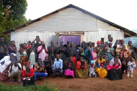 Locals at the islands display their new Bibles