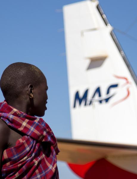 Boys of the Karamogong tribe watch the activity around MAF's aircraft at the Kotido airstrip, Uganda.