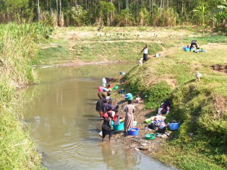 People washing their laundry in River Namatala