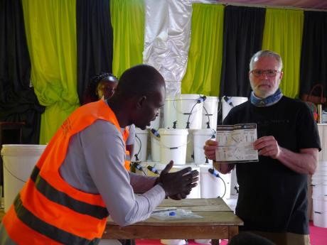 Jim Gentle showing bucket recipients how to use them